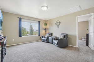 Sitting room featuring light carpet