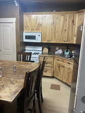 Kitchen featuring white appliances and sink