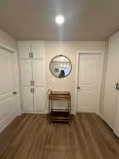 Doorway featuring a chandelier, wood-type flooring