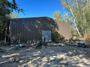 View of home's exterior featuring an outdoor structure