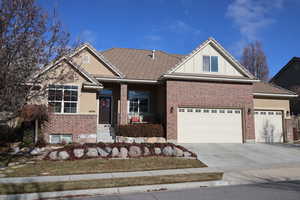 View of front of property featuring covered porch and a garage