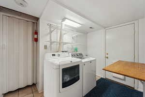 Laundry room in basement, with walkout entrance