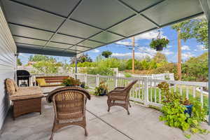 View of covered patio with a grill