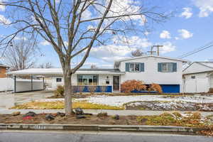 Tri-level home with view of the landscaping, photo taken in Jan