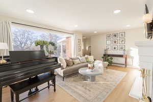 Living room with light hardwood / wood-style floors and a wealth of natural light