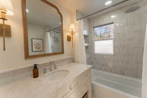 Bathroom featuring vanity and shower / tub combo