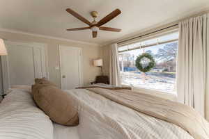 Bedroom featuring ceiling fan and ornamental molding