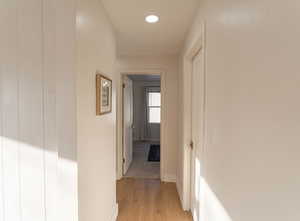 Hall with light hardwood / wood-style flooring