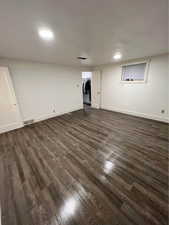 Basement with dark wood-type flooring