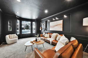 Living room featuring crown molding, carpet, and a textured ceiling