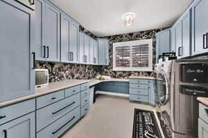 Laundry room featuring washer and dryer and cabinets