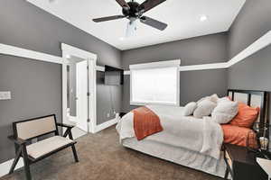 Bedroom with ceiling fan and carpet floors