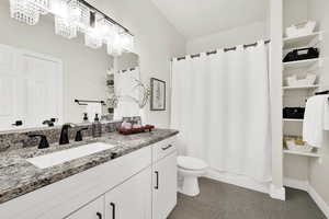 Full bathroom with vanity, tile patterned flooring, toilet, shower / tub combo with curtain