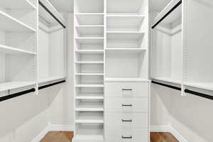 Spacious closet featuring hardwood / wood-style floors