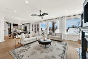 Family room featuring light hardwood / wood-style floors and ceiling fan