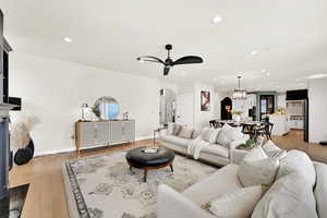 Family room with ceiling fan and light hardwood / wood-style floors