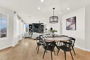 Dining space featuring light hardwood / wood-style floors and a fireplace