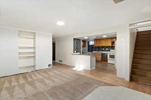 Unfurnished living room featuring sink