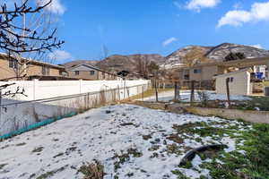 Snowy yard with a mountain view