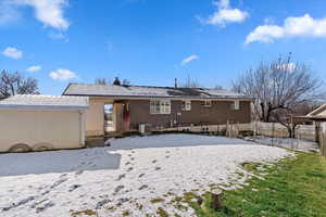 Snow covered property with central AC