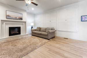 Living room featuring light wood-type flooring and ceiling fan