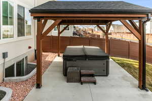 View of patio / terrace with a gazebo and a hot tub