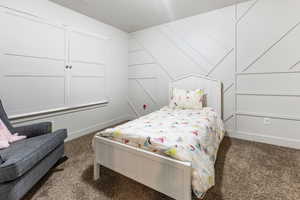 Bedroom 2 carpeted and featuring vaulted ceiling