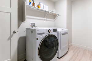 Laundry area with washer and clothes dryer