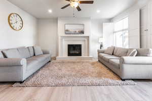 Living room featuring hardwood / wood-style flooring and ceiling fan