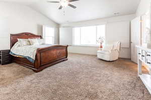 Primary bedroom featuring ceiling fan and vaulted ceiling