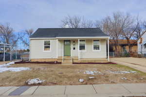 Bungalow-style house with covered porch and central AC unit