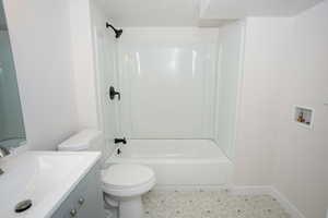 Full bathroom with shower / tub combination, vanity, a textured ceiling, and toilet