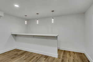 Interior space featuring decorative light fixtures and light hardwood / wood-style flooring