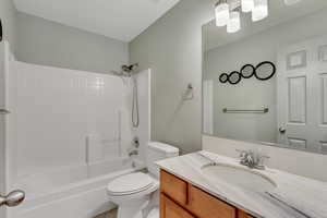 Full bathroom featuring bathing tub / shower combination, tile patterned flooring, vanity, and toilet