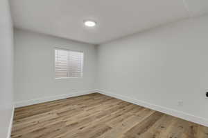 Unfurnished room with light hardwood / wood-style floors