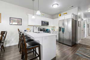 Bright Kitchen with Stainless Appliances & a Bar Seating Area