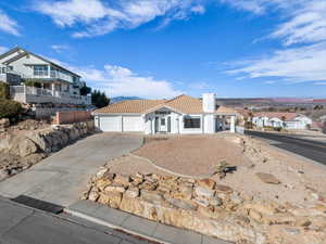 View of front of house featuring a mountain view and a garage