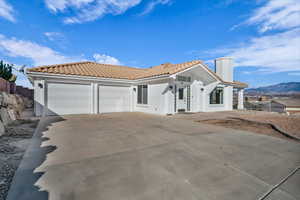 Mediterranean / spanish home featuring a mountain view and a garage