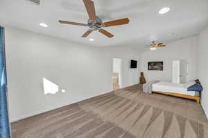 Unfurnished bedroom featuring carpet flooring, ensuite bathroom, a textured ceiling, ceiling fan, and lofted ceiling