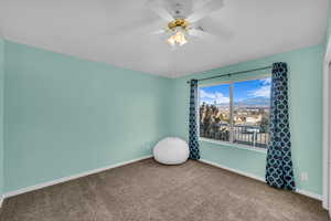 Unfurnished room featuring carpet flooring and ceiling fan