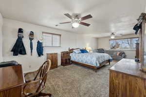 Carpeted bedroom with ceiling fan