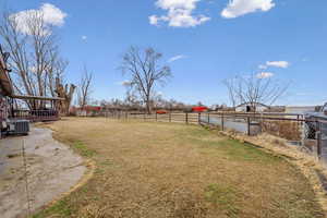 View of yard with a rural view and central air condition unit