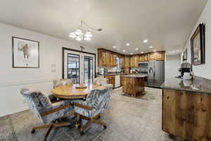 Dining area featuring sink and an inviting chandelier