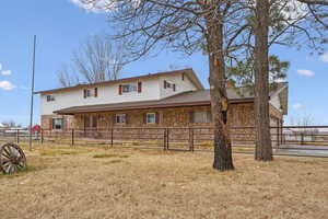 Back of house featuring a yard