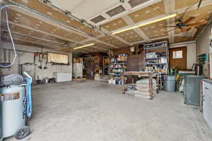 Garage with a workshop area and ceiling fan