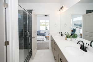 Bathroom with vanity, tile patterned floors, and a shower with door