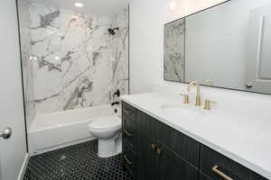 Full bathroom featuring vanity, toilet, and shower / tub combination