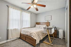 Bedroom featuring ceiling fan and light carpet