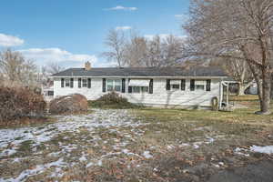 Ranch-style house with a lawn