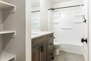 Full bathroom featuring tile patterned flooring, vanity,  shower combination, and toilet